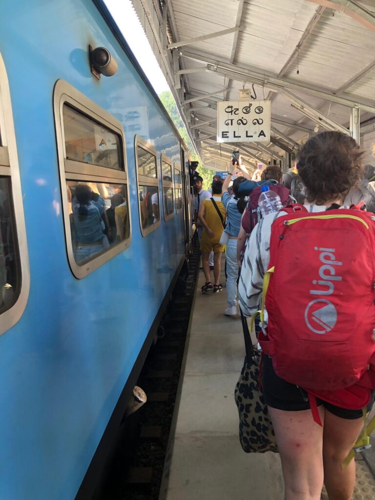 Sri Lanka backpacking: getting off the blue train on a busy platform at Ella station