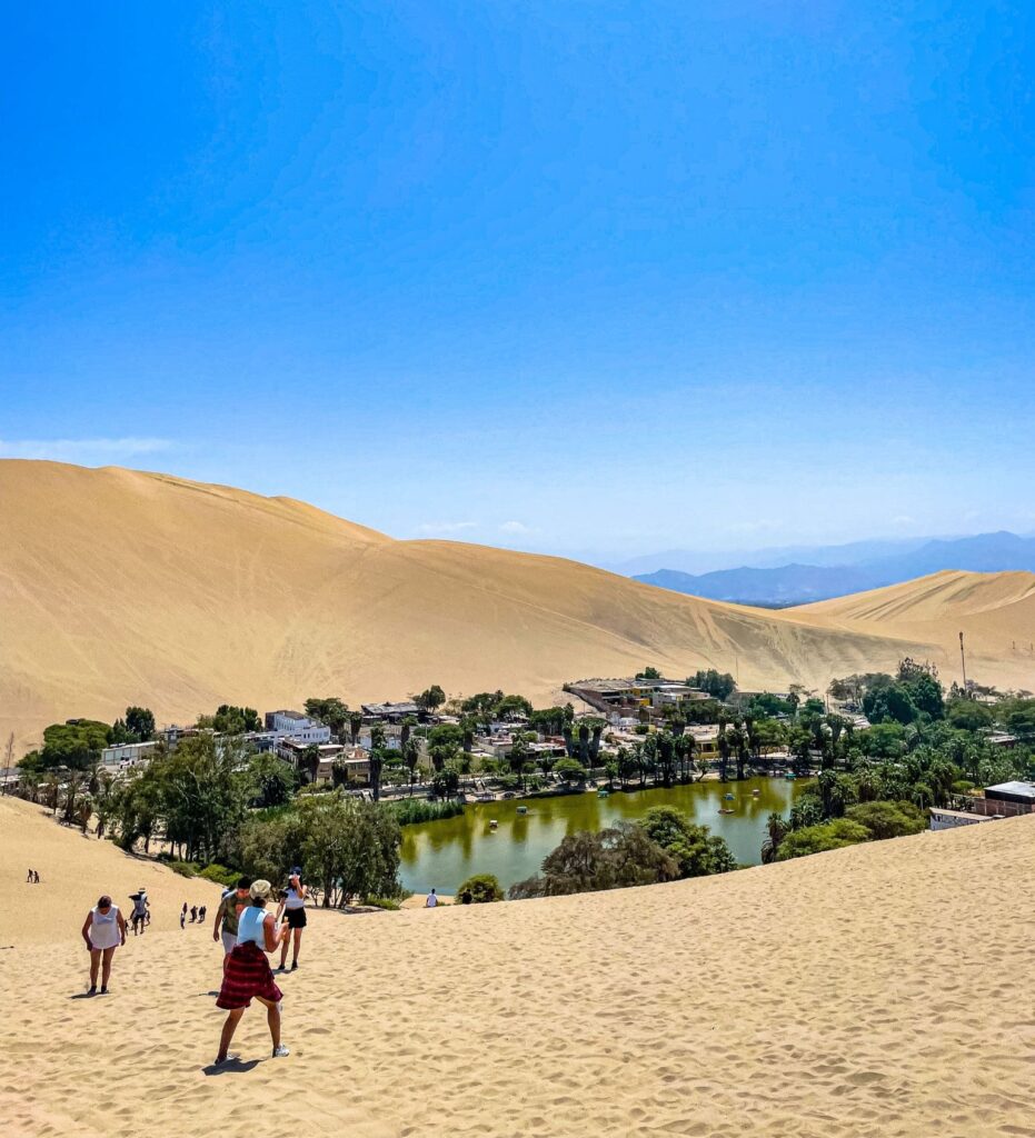Aerial view of the Huacachina oasis with its sand dunes in a Peruvian desert
