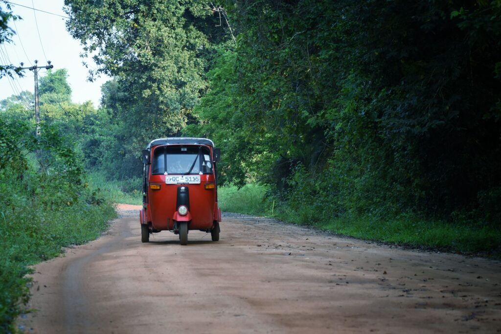 Tuktuk in Sri Lanka on a backroad surrounded by nature